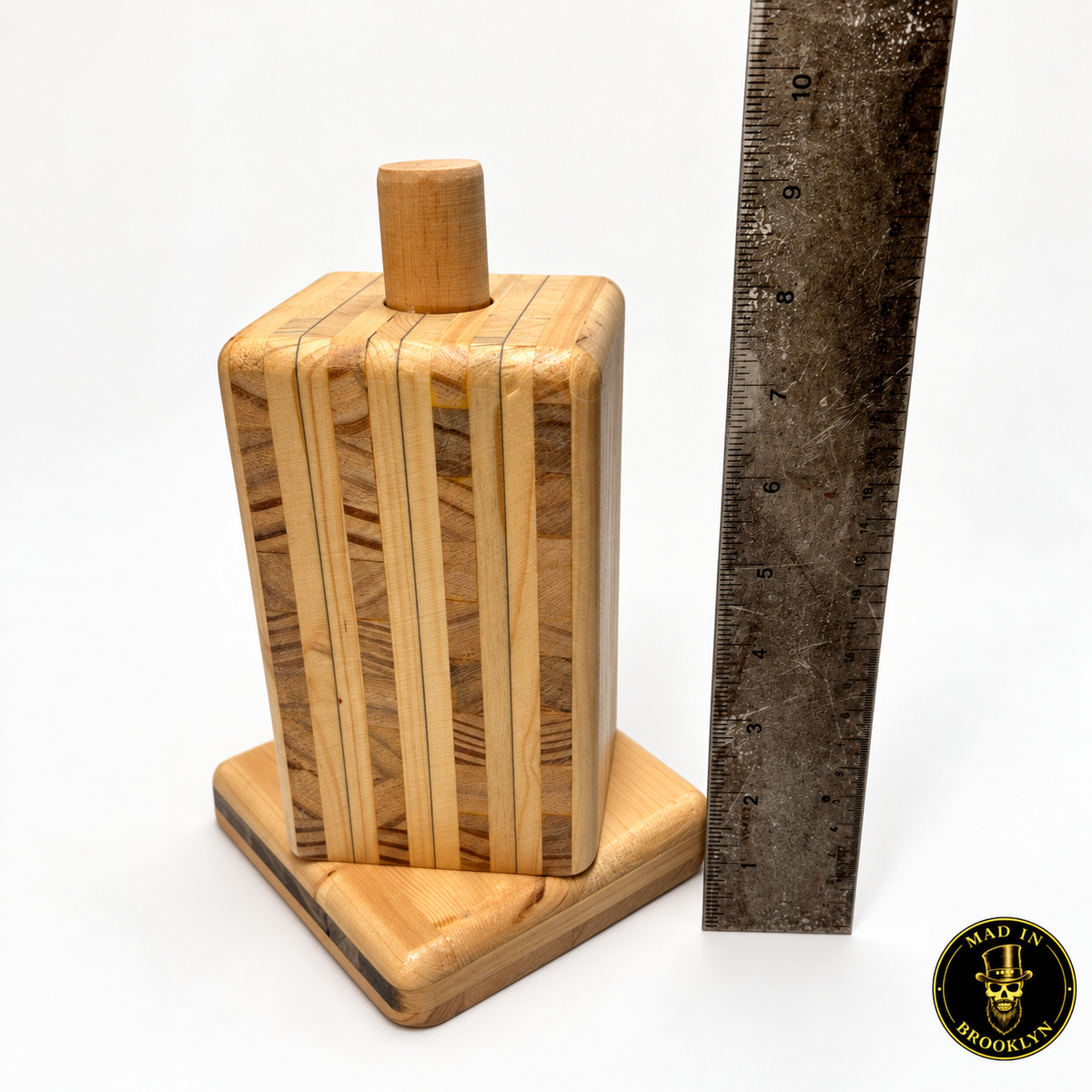 Wooden hat block spinner shown beside ruler for overall height