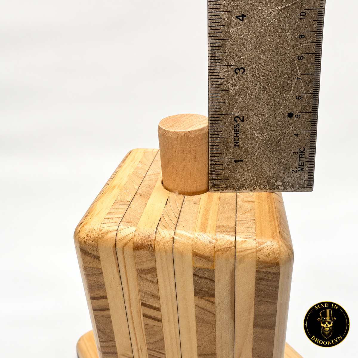 Wooden hat block spinner top peg shown beside ruler