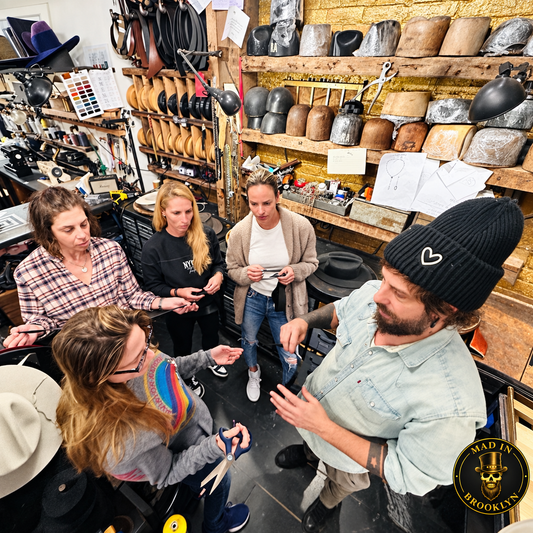 Private group learning hat-making techniques inside the Mad in Brooklyn studio